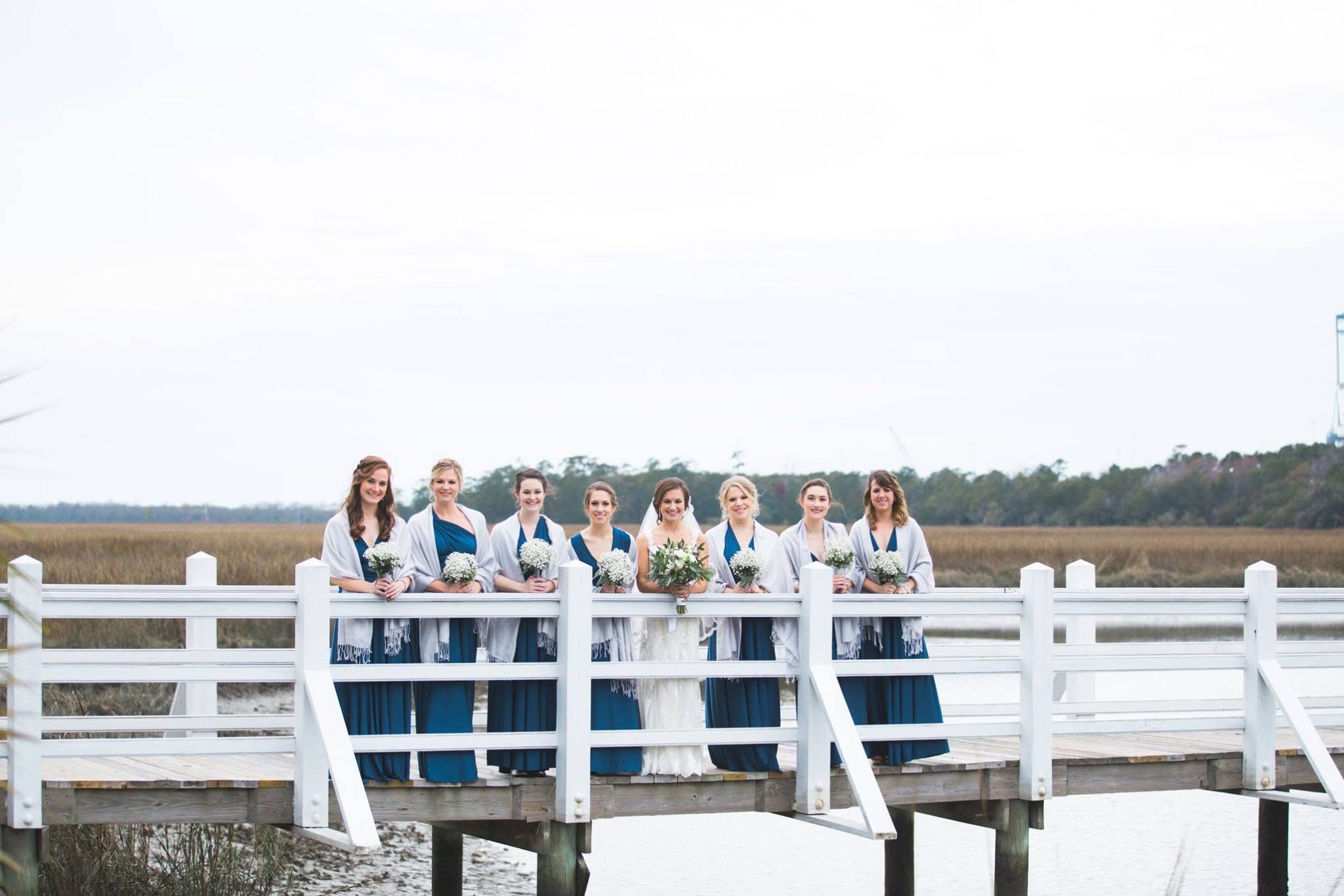 Fine art wedding details including custom place settings and lush floral arrangements